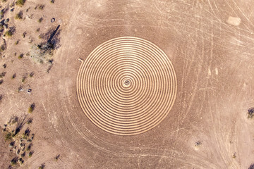 Labyrinth pattern carved in the desert sand in perfect circle shape. Aerial view from above. Found in Sonoran Desert of Arizona