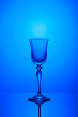 Empty wine glass on a blue background