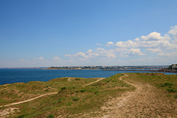 Mountain landscape with cloudy sky and sea shore. Beautiful nature