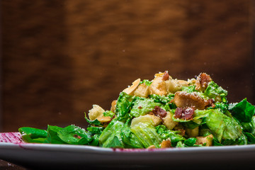 Ensalada cesar en plato blanco decorado con salsa de betbel