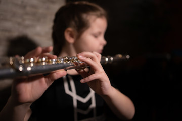 little girl playing the flute at home © Robert