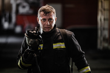 firefighter portrait wearing full equipment and emergency rescue equipment. taking off oxygen mask...