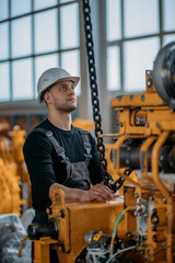 A worker works with a crane at the factory.