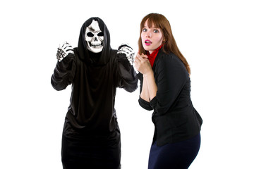 Scared businesswoman paranoid of catching a deadly disease represented by the grim reaper.  She is...