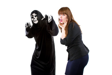 Scared businesswoman paranoid of catching a deadly disease represented by the grim reaper.  She is...