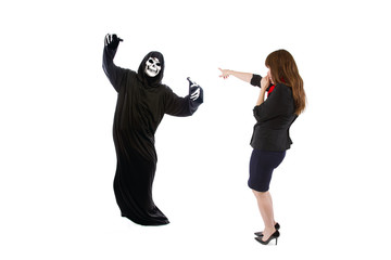 Scared businesswoman paranoid of catching a deadly disease represented by the grim reaper.  She is...