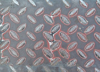 Background of metal diamond plate in red color.