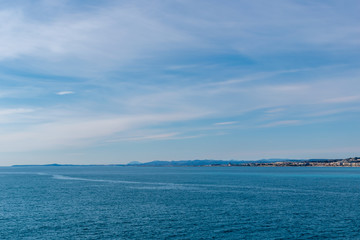 The panoramic view of the Mediterranean Sea and the hazy landscape on the horizon on a sunny day (Provence Côte d'Azur, France)