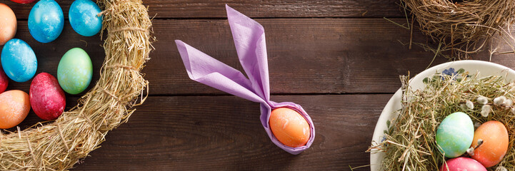 Still life of easter eggs in a bird's nest on a wooden background. Rustic. Decoration of natural. Easter celebration concept. Copy space. Flat lay. Banner.