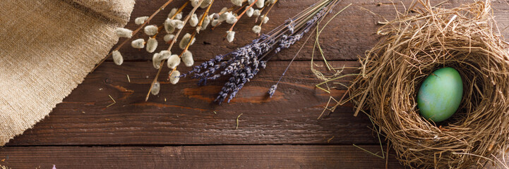Still life of easter eggs in a bird's nest on a wooden background. Rustic. Decoration of natural. Easter celebration concept. Copy space. Flat lay. Banner.