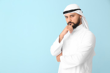 Handsome Arab man on color background