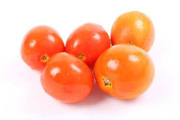 Pile of fresh tomatoes isolated on white background