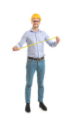 Male engineer with tape measure on white background