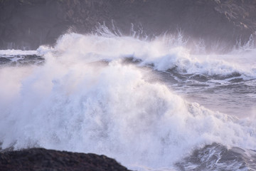 Powerful waves of the North Atlantic Ocean crash into the rocky shoreline of southern Iceland.