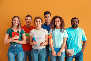 Young students of language school on color background