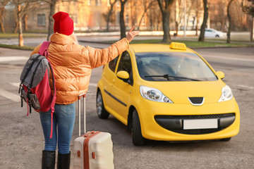 Tourist catching taxi on city street