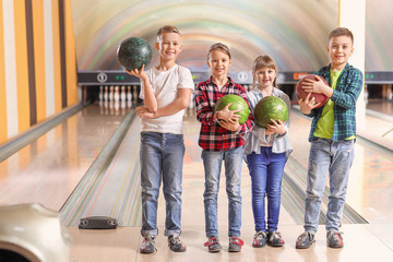 Obraz premium Little children playing bowling in club