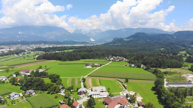 Aerial Over The Volcji Potok Arboretum On A Clear Sunny Day With Clouds And Forest In Background