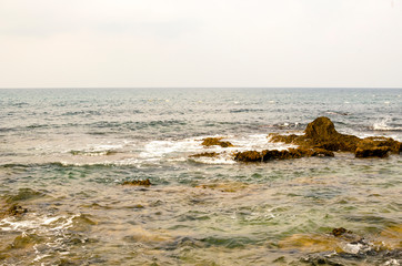 Fototapeta na wymiar sea wave is breaking on the stones of a steep shore
