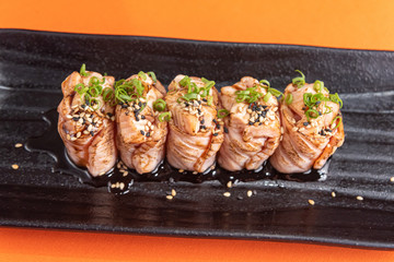 Delicious and beautiful sushi on the orange table