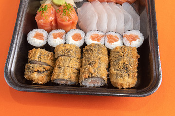Delicious and beautiful sushi on the orange table