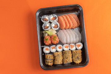 Delicious and beautiful sushi on the orange table