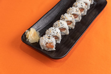 Delicious and beautiful sushi on the orange table