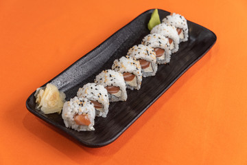 Delicious and beautiful sushi on the orange table