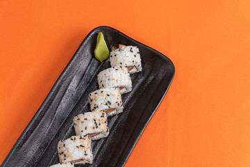 Delicious and beautiful sushi on the orange table