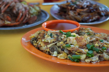 Delicious street food oh chien (Fried oyster omelette) is famous snack at Pulau Ketam restaurant.