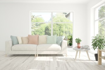 Minimalist living room in white color with sofa and summer landscape in window. Scandinavian interior design. 3D illustration