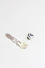 Liquid coronavirus COVID-19 vaccine is ready for use. Vertical format. Virus vaccine ampoule. Medicine and drug concept.