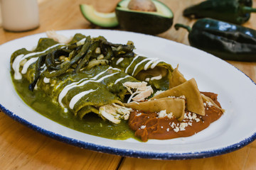 green enchiladas mexican food with tomato sauce and cheese in mexico