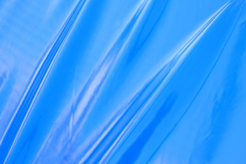Blue wavy reflective background. Wave lines on a blue background.