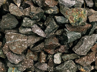Rough stones, crushed stone, granite gravel close-up