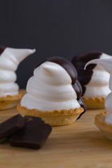 Fototapeta na wymiar cupcakes in the shape of penguins of meringue with chocolate