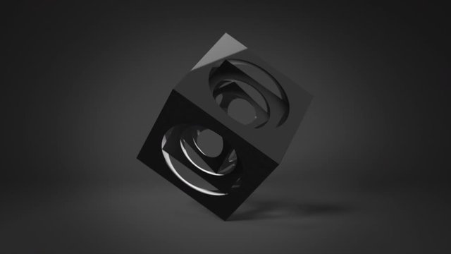 Looped 3d animation of the three black cubes with spherical hole inside, that rotate around a common axis on black background. Abstract 3d animation. Can be used as a background.