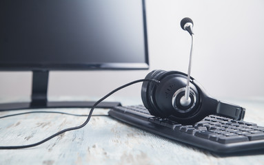Headset on computer keyboard. Customer service. Support
