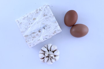 Garlics And Eggs And Tempe On  White Background