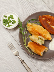 Plate with fried pies and a metal fork on a table.