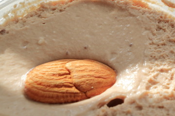 Image of almond nut on a chocolate curd dessert.