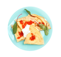 Delicious pancakes with caviar and cream isolated on white, top view