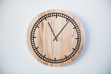 Round eco clock made of wood and epoxy. The subject of interior in your home. Natural handmade tree. Clock isolated on white background.