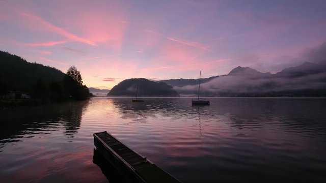 Peaceful autumn Alps mountain lake. Sunrise Wolfgangsee lake view, St. Wolfgang im Salzkammergut, Upper Austria.