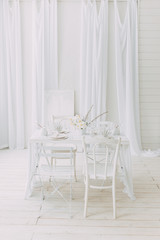  Coral and white printing in concept. Light interior of the photo Studio. White wedding table decor.