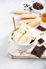 Mascarpone cheese  and Ingredients for making Italian dessert tiramisu on a light concrete background. Top view with copy space.