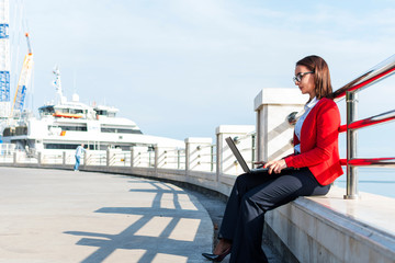 Business woman working with a laptop outdoors. A woman with a laptop.