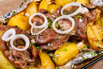 baked in foil pork neck and potatoes and onion