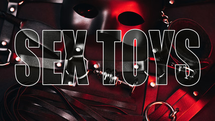 Creative inscription Sex Toys on the background of a sexual set for BDSM sex