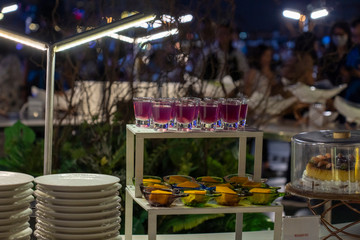 Desserts on the food shelf in the buffet item at night